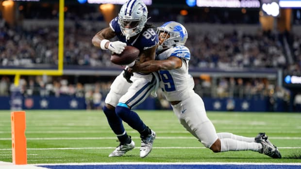 Dallas Cowboys wide receiver CeeDee Lamb (88) fumbles the ball as Detroit Lions cornerback Kindle Vildor (29) applies pressure during the first half of an NFL football game, Saturday, Dec. 30, 2023, in Arlington, Texas. The ball rolled into the Lions end zone and was ruled a touchback. (AP Photo/Sam Hodde)   